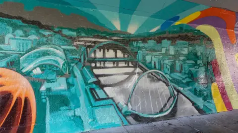 Newcastle City Council Mural showing the Tyne Bridge and Millennium Bridge as well as the Glasshouse International Centre for Music (formerly known as The Sage).