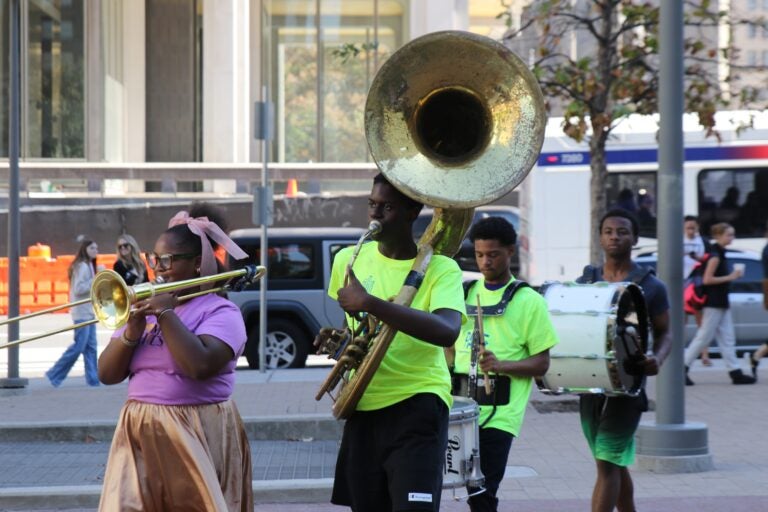 people playing brass instruments and drums