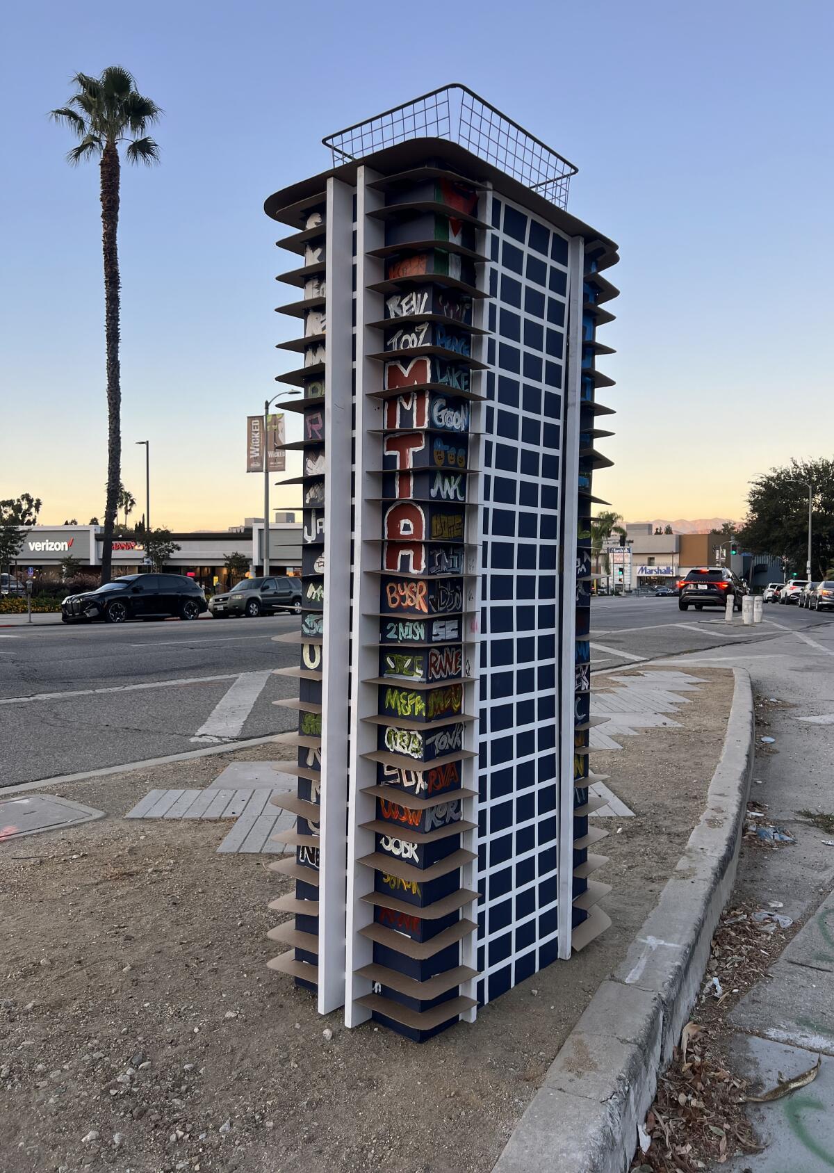 A model of a skyscraper set on a roadway median