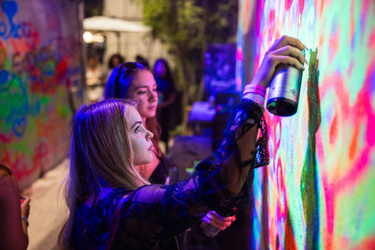 women stray painting at the Street Art After Dark event at Wynwood Walls