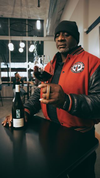 a man stirring a glass of wine