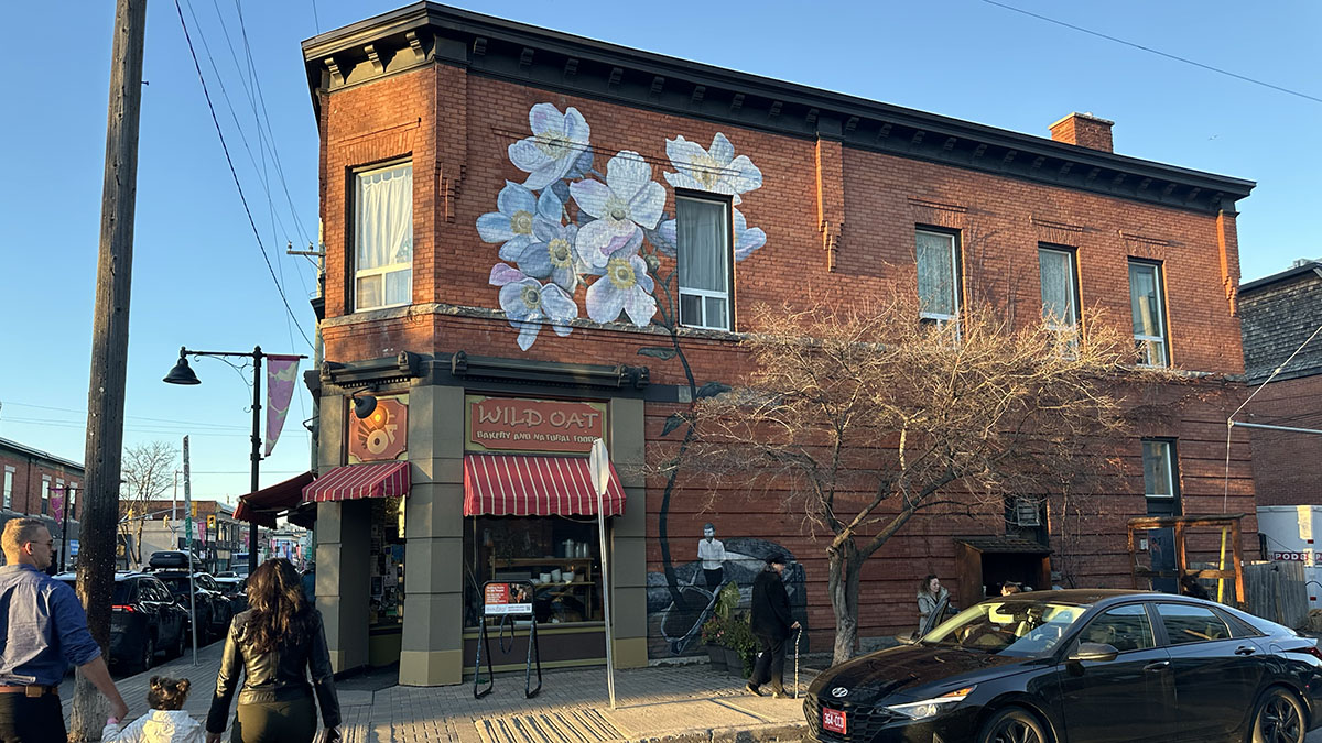 Painted flowers cover the side of Wild Oat Bakery