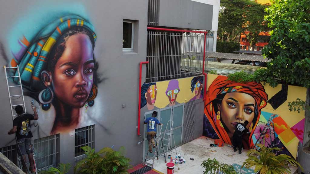 Artists who came to participate in the first edition of Graff Ivoire, create graffiti and murals on the facade of Ibis hotel in Abidjan, Ivory Coast Nov 16, 2024. REUTERS/Luc Gnago