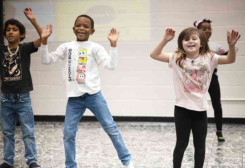 King Rayfield, center left, and Paisleigh Reese warm up before a dance class with Rooted Movement Collective on Wednesday, Jan. 29, 2025, at Harmony Leadership Academy in Texarkana, Ark. (Staff photo by Stevon Gamble)