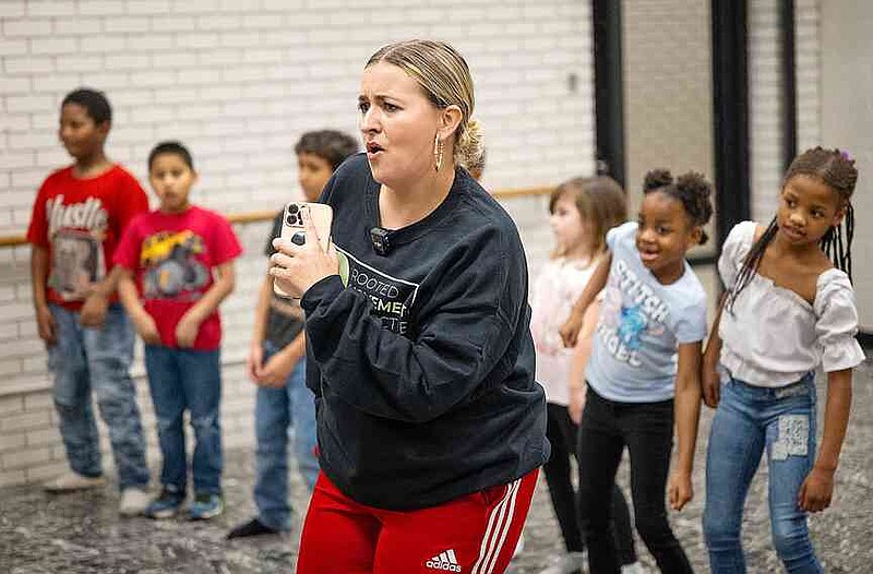 CeCe Marie, artistic director of Rooted Movement Collective, teaches a hip-hop dance move to a group of second-graders Wednesday, Jan. 29, 2025, at Harmony Leadership Academy in Texarkana, Ark. Marie and fellow dancers Todd Belin, Blake Worthey and Zoe Cordasco are in residency at the school through Friday. The performers, who are from Northwest Arkansas, are guiding students in exploring the African roots of popular dance styles and their place in the culture of the United States. On Wednesday, Marie taught students dance steps called the bounce, chest isolation and rock. (Staff photo by Stevon Gamble)