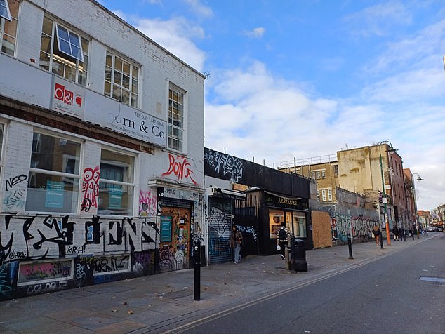 Shops with graffiti on them in Whitechapel. Stepping out of Whitechapel Station, graffiti is immediately visible in surrounding areas