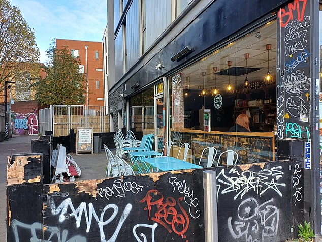 A café that has had graffiti sprayed over its walls. Mile End Road outside the station is among the areas with the most graffiti