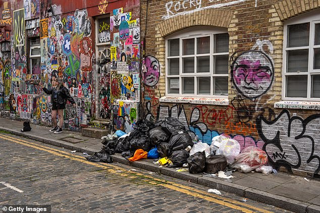 Shocking photos show the extent of the rubbish on a street off Brick Lane as it appears alongside the long-standing graffiti