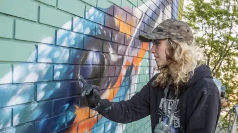 Street Art Atlas A close-up of artist Megan Russell, working on her nominated spray painting, 