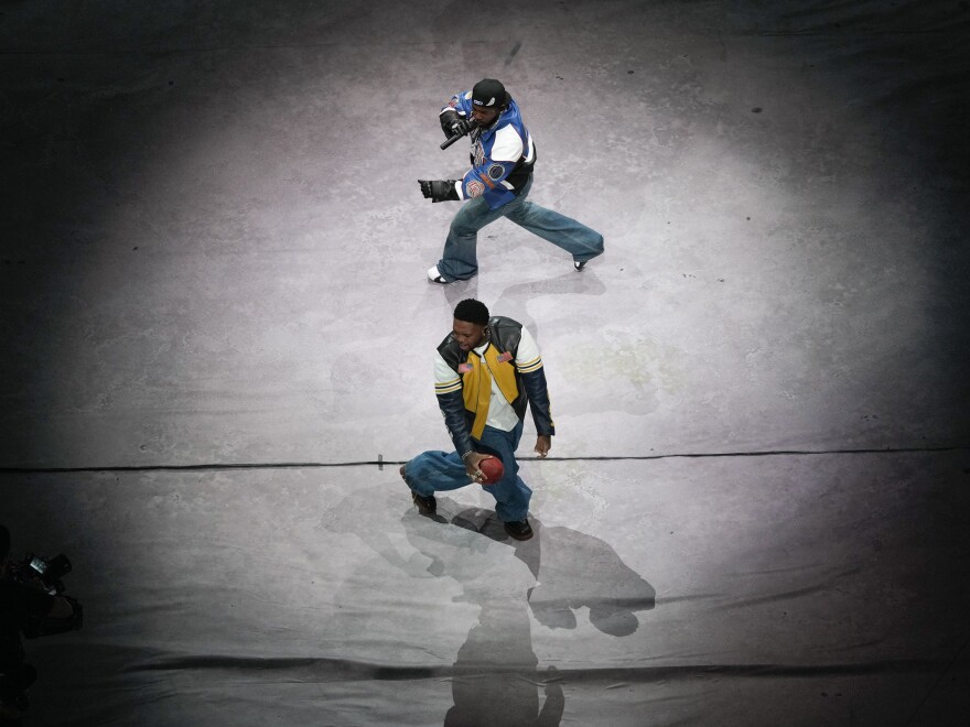 DJ Mustard, bottom, and Kendrick Lamar perform during halftime of the NFL Super Bowl LIX.