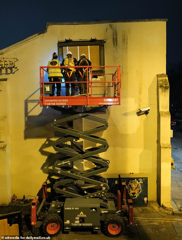 Images taken at the site show the art being carefully sealed off by builders