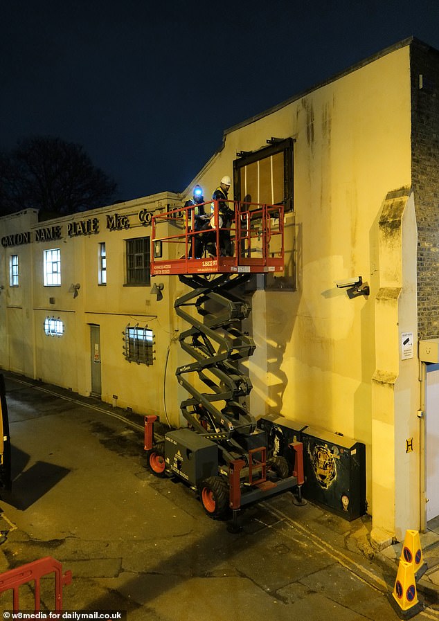 Images show the team sectioning off the area where the art was sprayed last summer