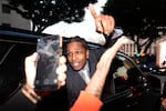 A$AP Rocky gestures out of the window of a vehicle while leaving court after he was found not guilty in his trial Tuesday in Los Angeles.