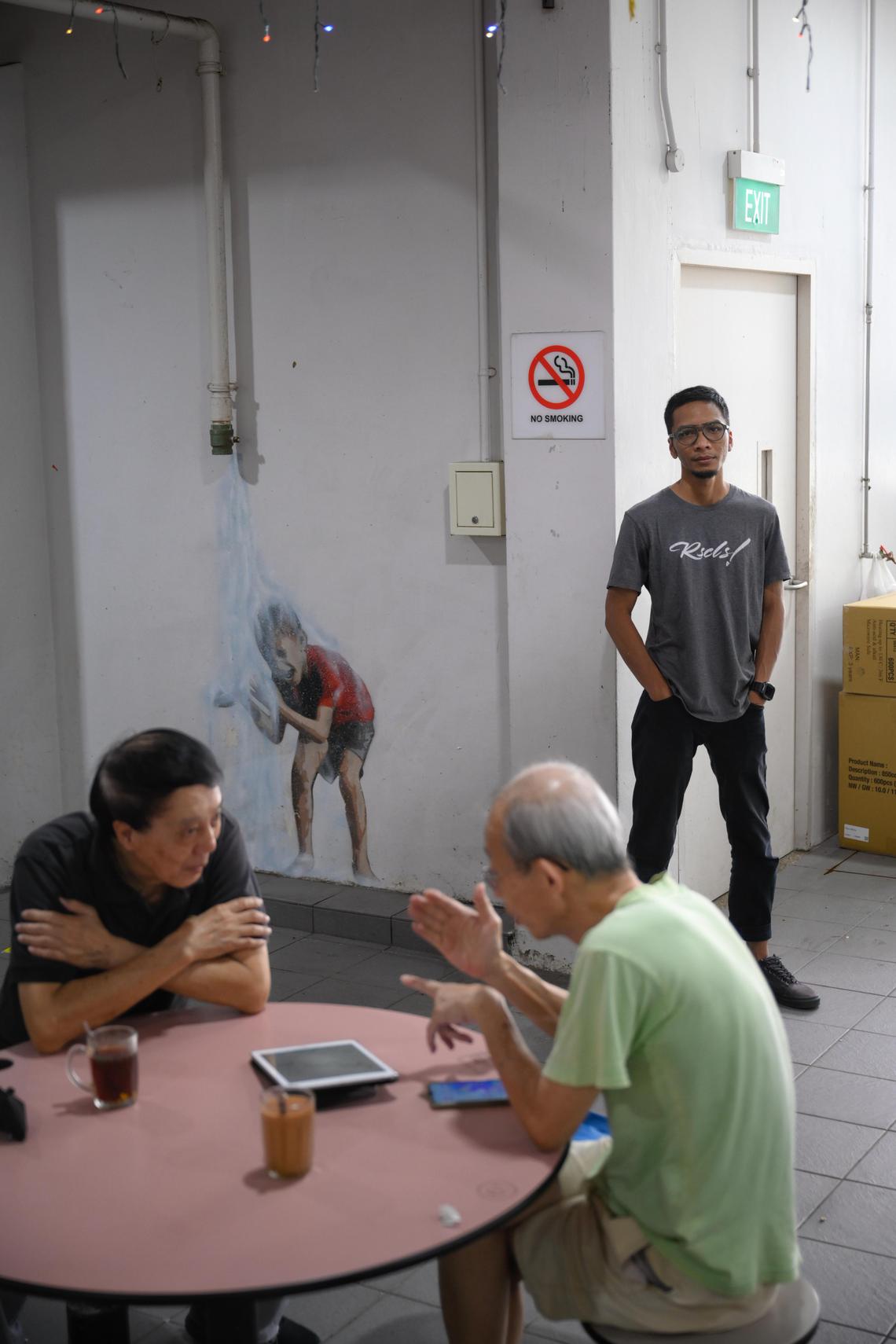 Street artist Sufian Hamri, also known as TraseOne, pictured with a mural which he did with Queenstown residents at Mei Ling Market and Food Centre on Feb 4, 2025.