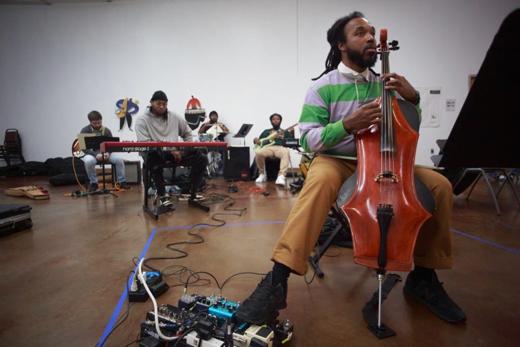 Jordan Hamilton sits with an idiosyncratic, spiky electric cello.