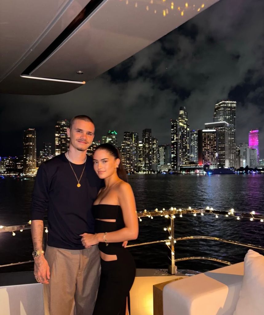 Romeo Beckham and Kim Turnbull in front of a Miami backdrop on the Beckham family yacht