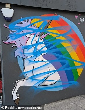 An artist who once punched his girlfriend in the face at a gallery opening has been accused of marring works by Brighton graffiti creators who have spoken out about his past abuse. Pictured, a work of Sprite's covered by blue paint