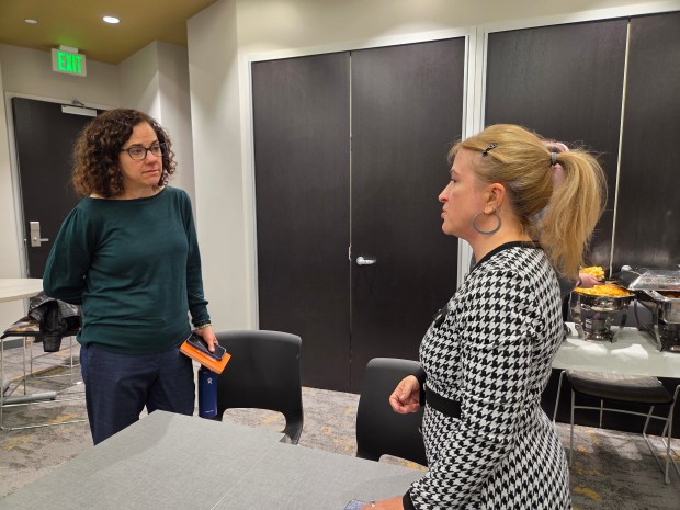 Mary Beth Connolly, of Porter, left, chats with Ska historian Heather Augustyn after Augustyn's recent talk, 