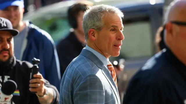 Brian Steel outside court today. He is wearing a blue and grey checkered suit over blue shirt.