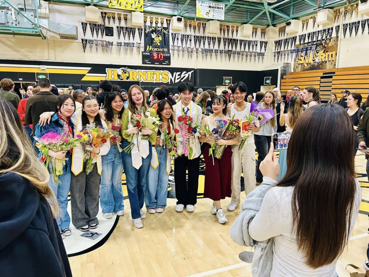 Alameda Post - dancers in their street clothes greet attendees, hold flowers, and smile through tears