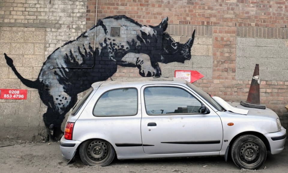 epa11546921 A new animal-themed artwork by Britain-based street artist Banksy featuring a rhino on a wall, in Charlton, southeast London, Britain, 12 August 2024. It is the eighth animal artwork the British artist has released in the past eight days across London. EPA/ANDY RAIN