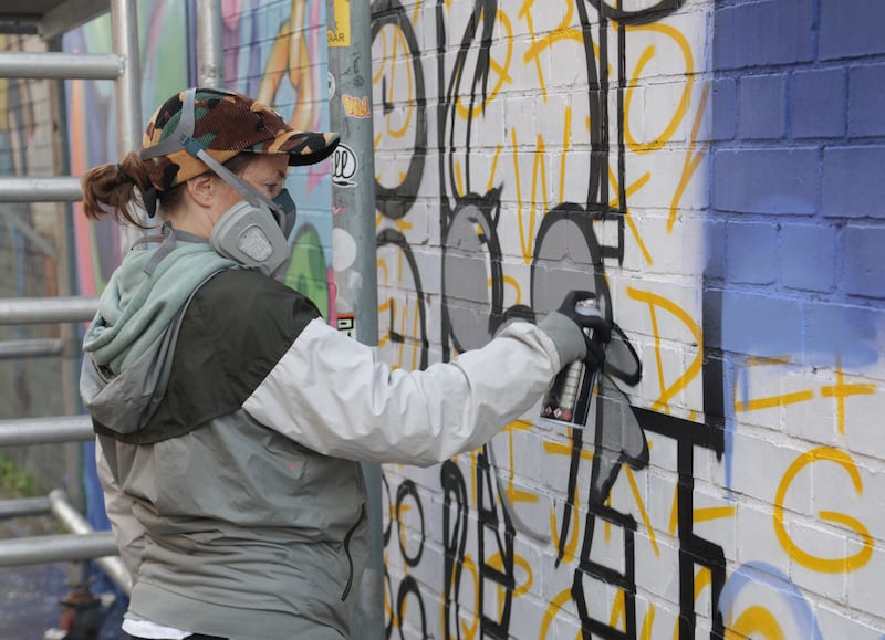 Artists on Talbot street as part of the Belfast Street Art festival. PICTURE COLM LENAGHAN