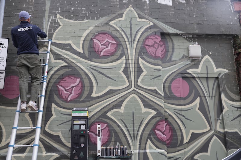 Artists on Talbot street as part of the Belfast Street Art festival. PICTURE COLM LENAGHAN