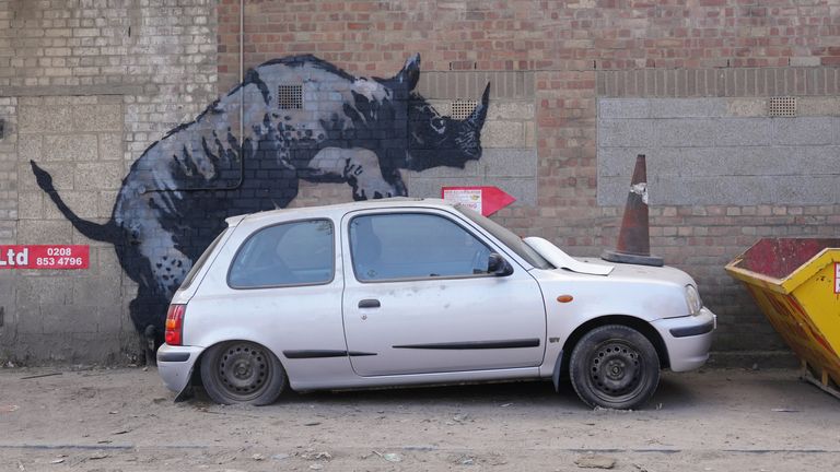 Banksy's eighth animal image is a rhino mounting a car in Charlton, southeast London. Pic: PA