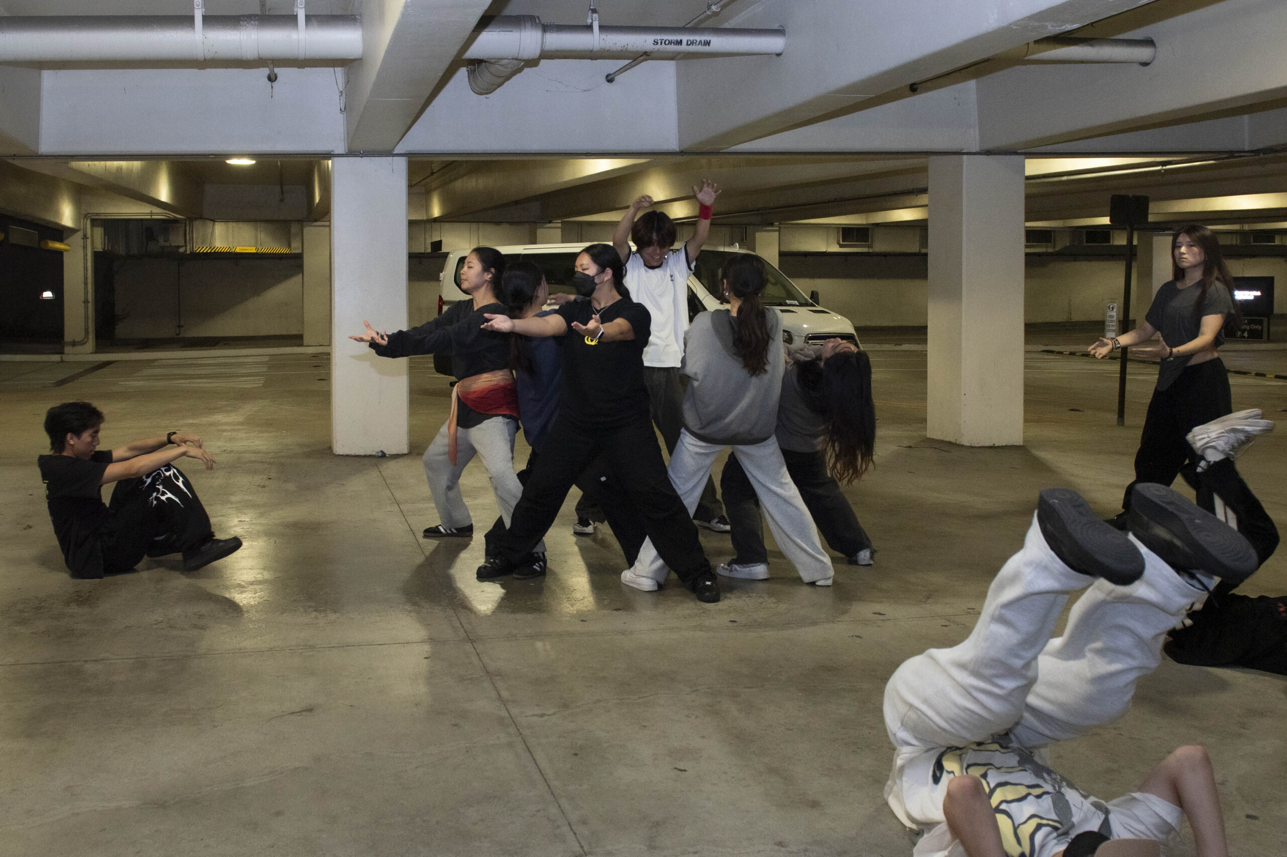 Students in ACA All Day dance in a parking garage while practicing several different movements. Fourth-year psychology student Tiffany Papazian said the team practices for performances in Parking Lot 4, sometimes for more than five hours at a time. (Leydi Cris Cobo Cordon/Daily Bruin senior staff)