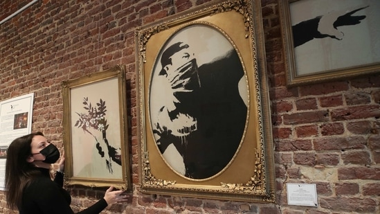 An art handler shows to reporters work