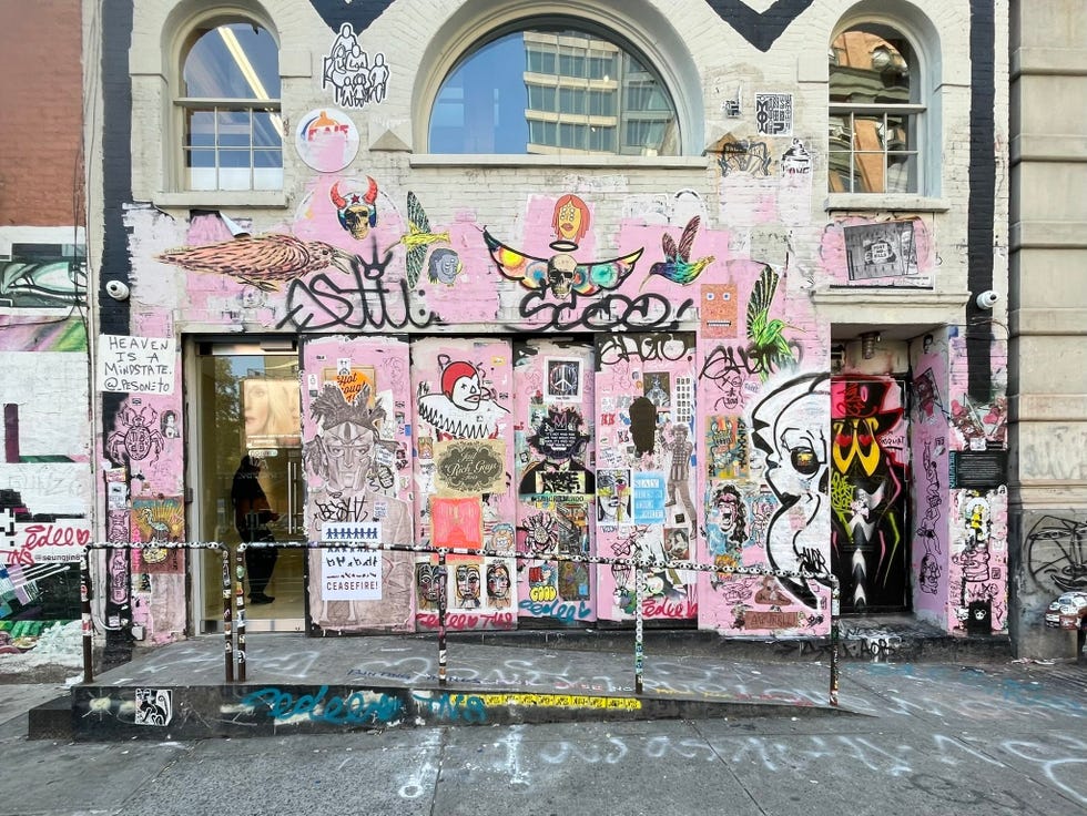 graffiticovered building facade with multiple art styles and messages