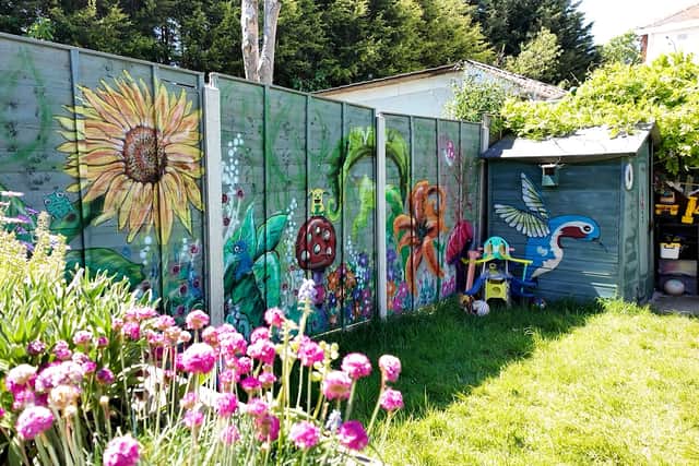 Omani Hamer painted her fence with a flower mural. Photo credit: Lucinda Herbert
